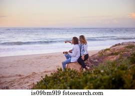 Couple relaxing on beach, Plettenberg Bay, Western Cape, South Africa