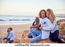 Friends relaxing on beach, Plettenberg Bay, Western Cape, South Africa