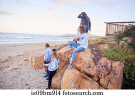 Friends relaxing on beach, Plettenberg Bay, Western Cape, South Africa