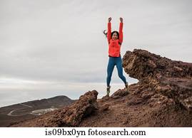 Happy woman at summit of mountain, Haleakala National Park, Maui, Hawaii