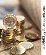 Still life of British currency on financial newspaper, close-up