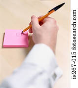 Man writing on square pad