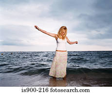 Young woman standing in sea