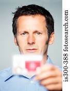 Man holding an identity card