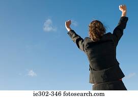 Businesswoman with arms raised