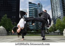 Businesspeople practising capoeira