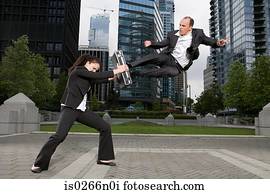 Businesspeople practising capoeira