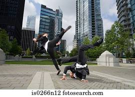 Businesspeople practising capoeira