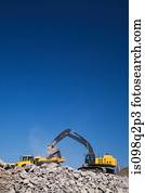 Excavator on piles of rubble