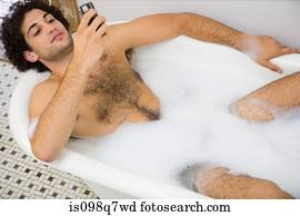 Man using a cellular telephone in the bath