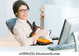 Man with guitar in office