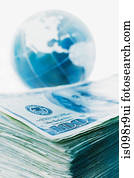 Stack of banknotes and globe