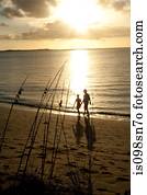 Couple on beach at sunset.