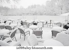 Snow on chairs in the park