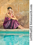 Woman by swimming pool with cellphone