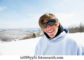 Young man wearing sunglasses and hooded top, portrait