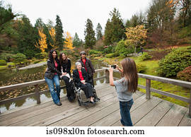 Girl photographing multi generation family