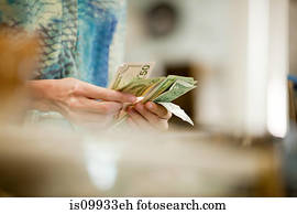 Shop keeper counting money in shop