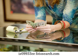 Shop keeper counting money in shop