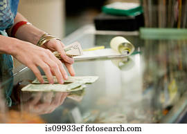 Shop keeper counting money in shop