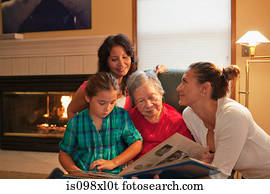 Three generation family looking at photo album