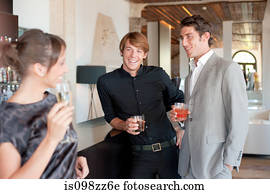 Two men flirting with woman in bar
