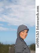 Portrait of mid adult woman in striped hooded top