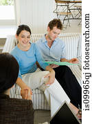 Couple meeting financial advisor at home
