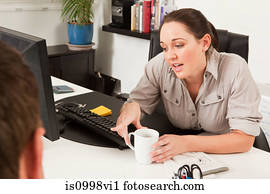 Female worker discussing work with a colleague
