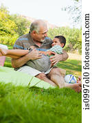 Grandfather playing with grandson in park
