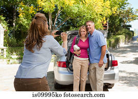 Mature woman photographing family
