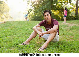 Mid adult man sitting in park, portrait