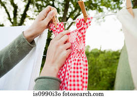 Woman hanging laundry on clothesline