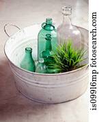 Bottles and plant in an old tub