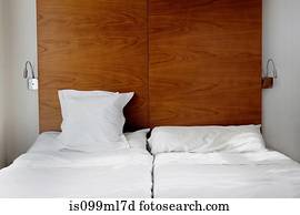 Empty bed with white bed linen