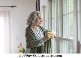 Senior woman looking out of window Senior woman looking out of window