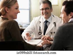 Young couple in doctor's office receiving good news