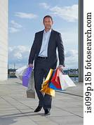 Mid adult man carrying shopping bags