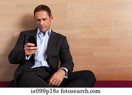 Mid adult man texting, portrait