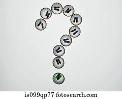 Dispenser cups of pills forming a question mark