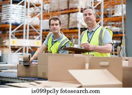 Two men checking stock in warehouse