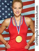 Young woman in front of USA flag with gold medal