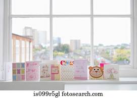 Greetings cards for new baby girl on windowsill