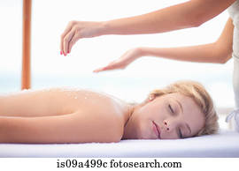 Woman having salt scrub on beach