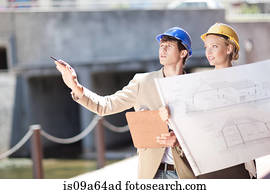 Business people reading blueprints