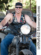 Man in leather vest on motorcycle
