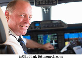 Pilot smiling in airplane cockpit