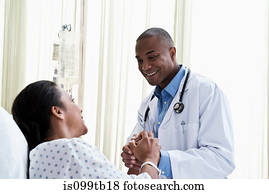 Doctor holding hands with patient