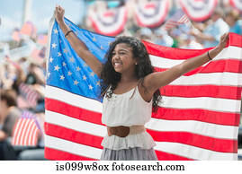 Girl at rally holding up american flag