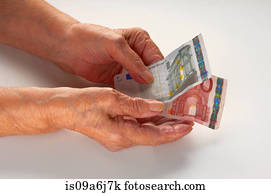 Older woman holding Euro notes